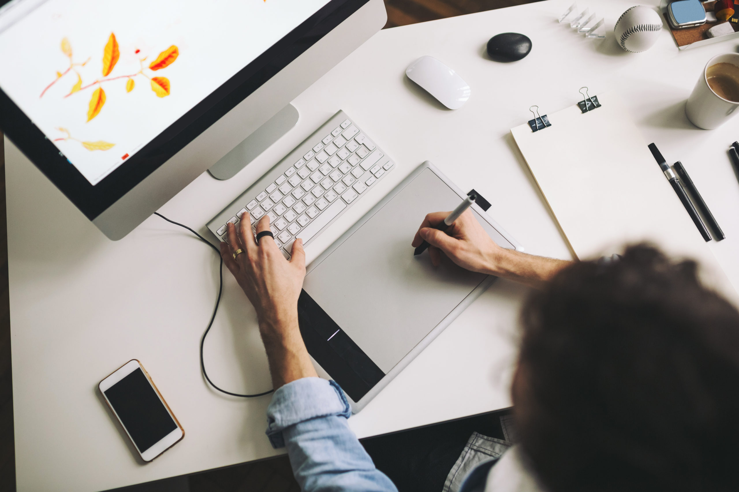 Modern designer sitting in front of computer and working in office